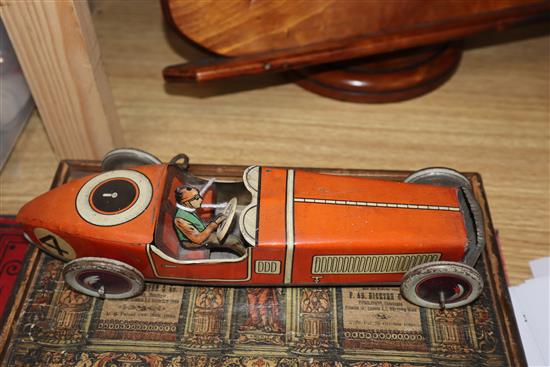 A Chad Valley tinplate racing car and a collection of other tinplate clockwork models,